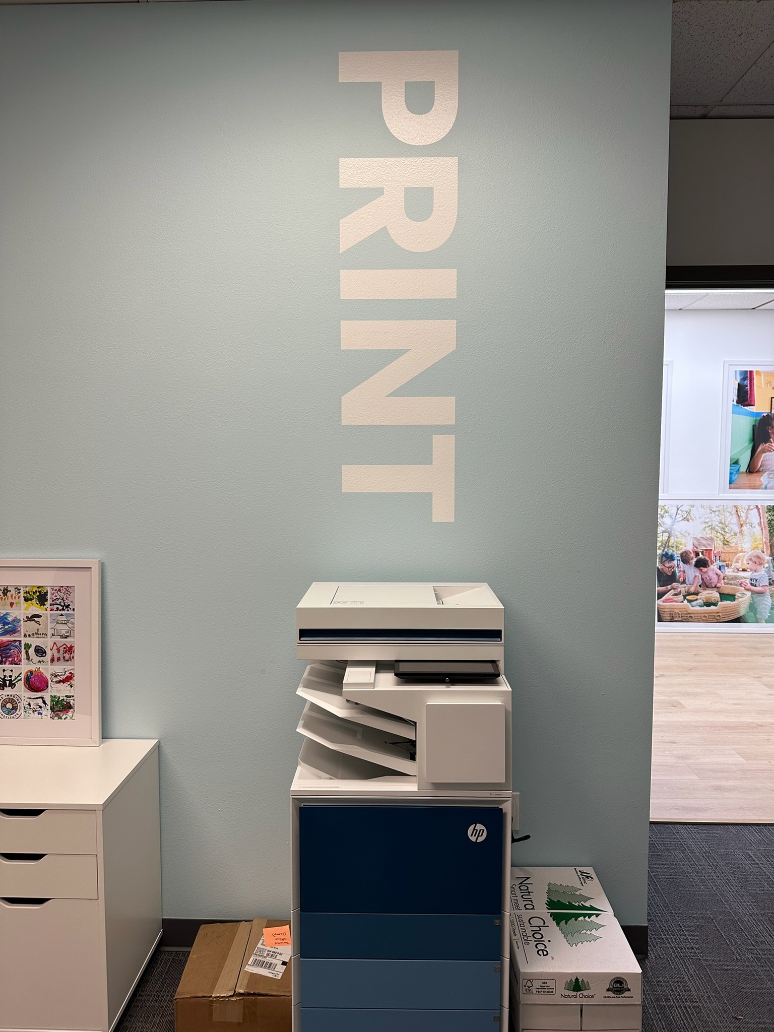 Vertical white Print lettering on a painted blue wall