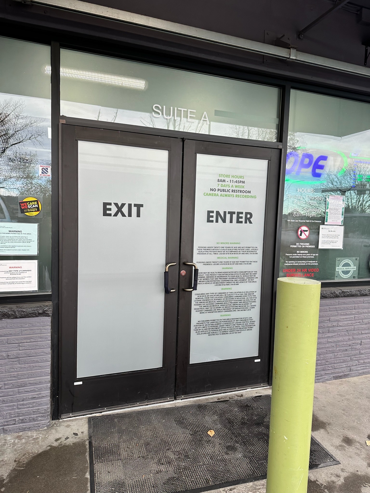 Kush21 frosted entrance doors with entry and exit lettering