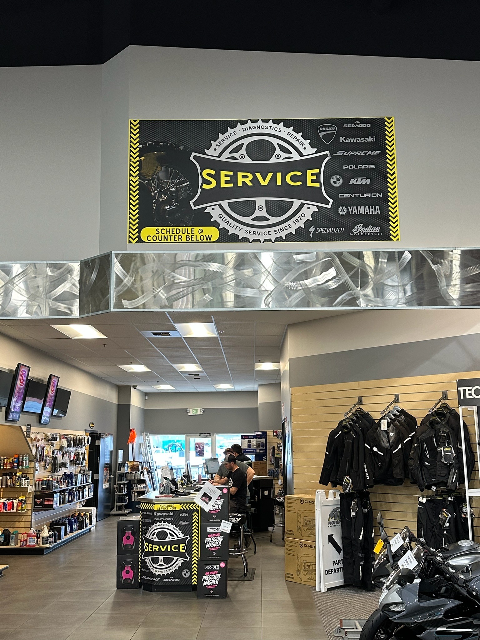 Lynnwood Motoplex service-area wall graphics and branded counter
