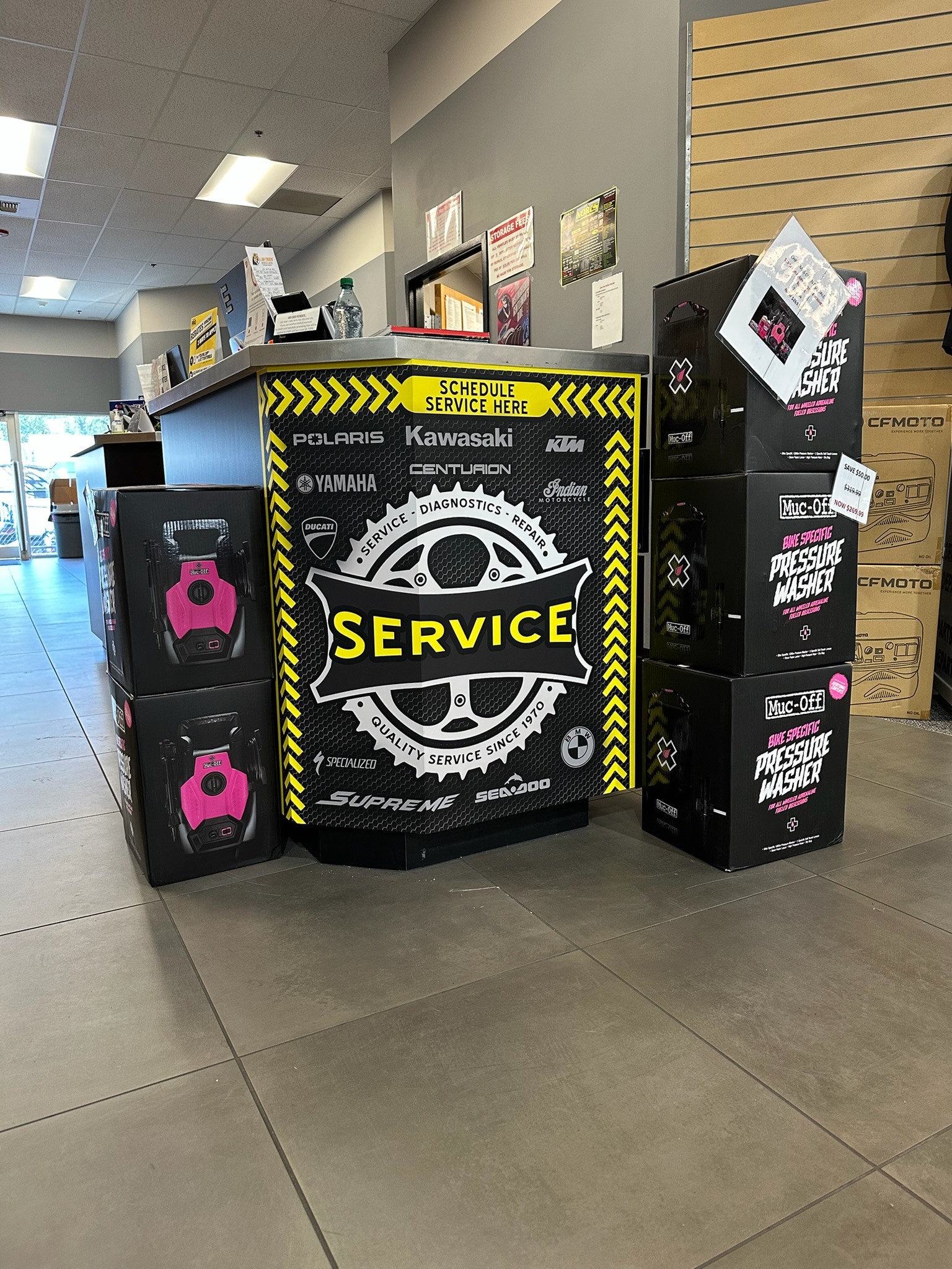 Lynnwood Motoplex service-desk wrap with black and yellow graphics